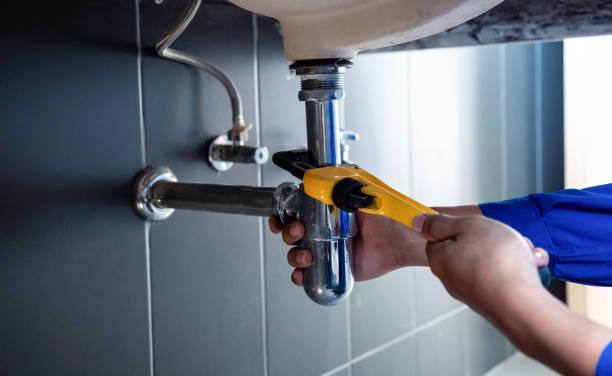 plumbing repair technician inspecting residential pipes
