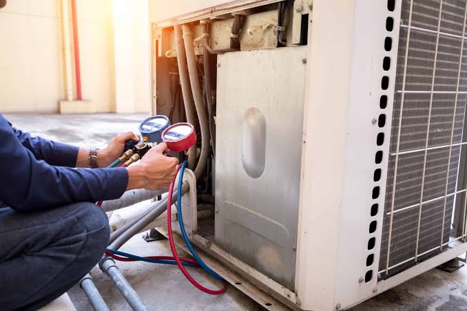 HVAC technician inspecting a residential furnace
